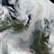 A satellite image from August 2, 2021 showing fire hot spots and the smoke plume stretching from Russia to the North Pole.